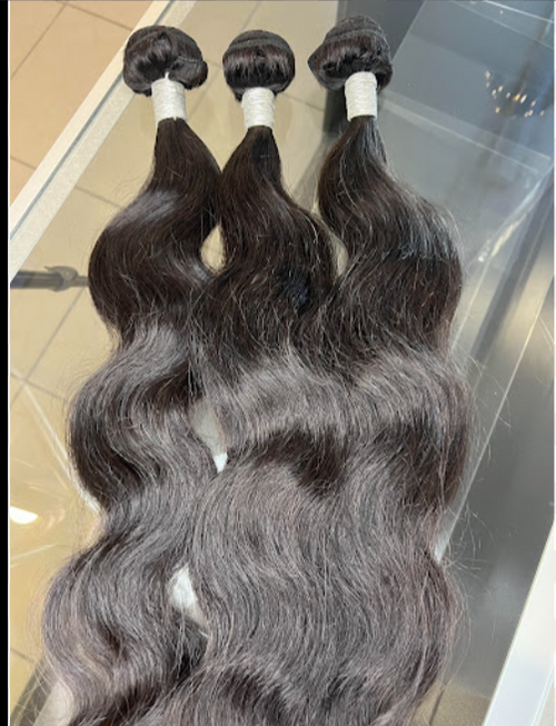 Three bundles of dark brown hair extensions on a reflective surface. Bleach friendly, Dye friendly, Heat friendly, no shedding. 